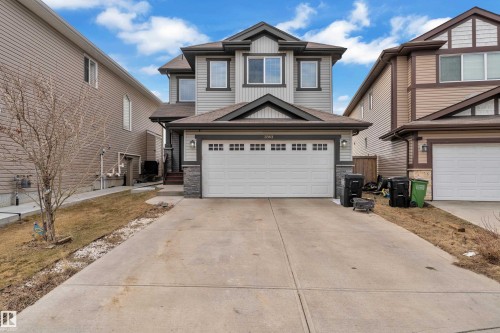 Two-story residence featuring light gray siding with dark trim accents and a prominent front-facing gable - 3363 13 Avenue, Edmonton, AB - Outdoor With Facade