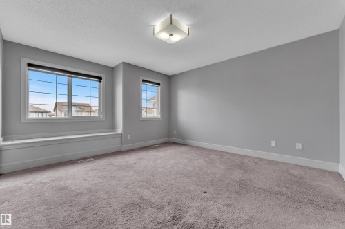 Carpeted room with light grey walls and white trim - 3363 13 Avenue, Edmonton, AB - Indoor Photo Showing Other Room