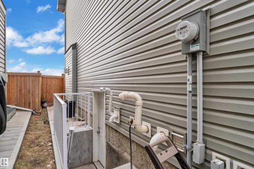 Gray siding exterior with a dedicated utility meter - 3363 13 Avenue, Edmonton, AB - Outdoor