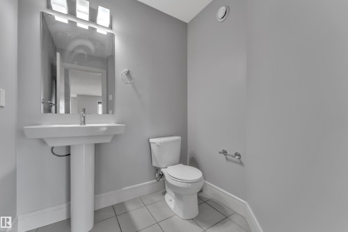Pedestal sink with a rectangular basin, chrome faucet, and mirrored vanity - 3363 13 Avenue, Edmonton, AB - Indoor Photo Showing Bathroom