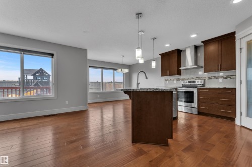Open-concept kitchen and living area featuring wood-finish flooring - 3363 13 Avenue, Edmonton, AB - Indoor Photo Showing Kitchen