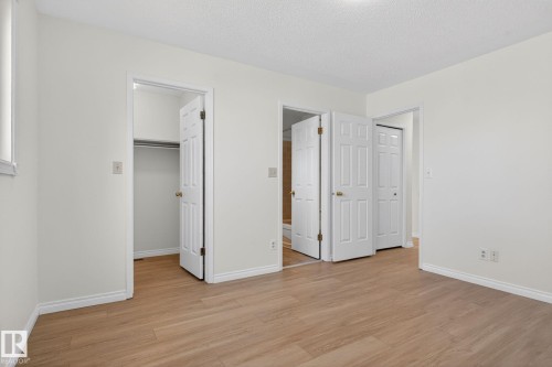 Interior room featuring wood-finish flooring, white painted walls, and white trim - 8403 190 Street, Edmonton, AB - Indoor Photo Showing Other Room