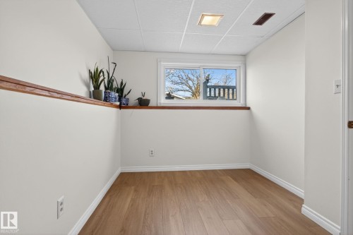 Room featuring wood-finish flooring, white baseboards, and light-toned walls - 8403 190 Street, Edmonton, AB - Indoor Photo Showing Other Room