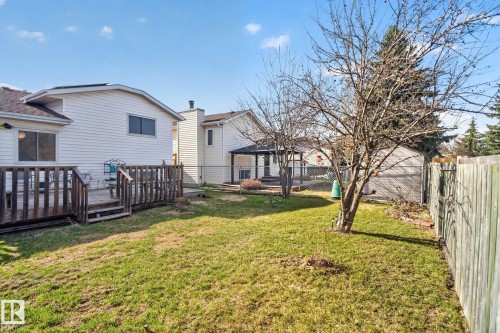 Spacious backyard with a grass lawn, wood deck, and mature tree - 8403 190 Street, Edmonton, AB - Outdoor