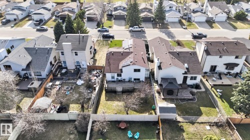 Spacious backyard featuring a manicured lawn, a fire pit area, and a privacy fence - 8403 190 Street, Edmonton, AB - Outdoor With View