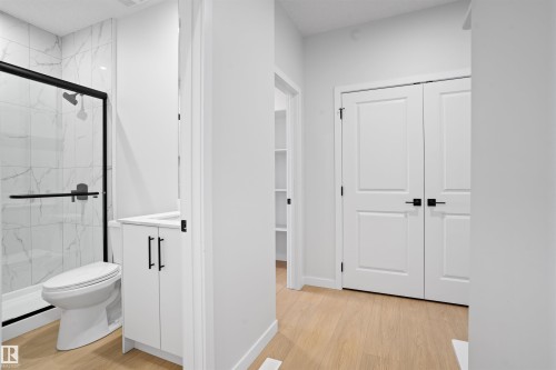 Bathroom featuring a walk-in shower with clear glass enclosure and black trim - 1849 Crossbill Loop, Edmonton, AB - Indoor