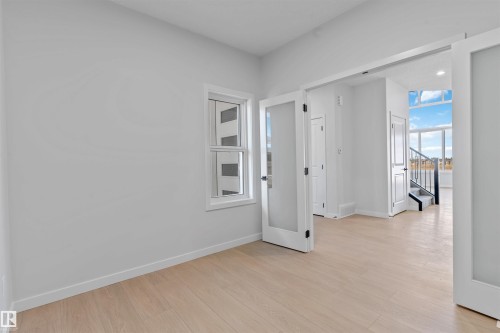 Bright interior space featuring light wood-finish flooring - 1849 Crossbill Loop, Edmonton, AB - Indoor Photo Showing Other Room