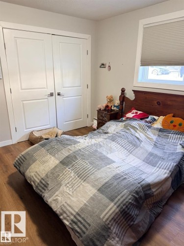 Wood-finish flooring throughout - 106 10725 111 Street, Edmonton, AB - Indoor Photo Showing Bedroom