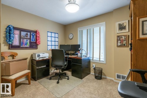 Dedicated room featuring a window with horizontal blinds, carpeted flooring, and neutral wall paint - 47 1130 Falconer Road, Edmonton, AB - Indoor Photo Showing Office