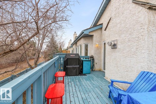Expansive outdoor deck featuring blue-painted wood flooring and railing - 47 1130 Falconer Road, Edmonton, AB - Outdoor With Deck Patio Veranda With Exterior