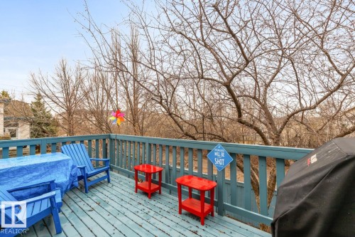 Outdoor deck featuring wood-finish flooring and a painted wood railing - 47 1130 Falconer Road, Edmonton, AB - Outdoor With Deck Patio Veranda