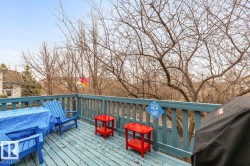 Outdoor deck featuring wood-finish flooring and a painted wood railing - 