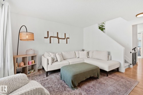Spacious living area featuring light wood-finish flooring and a plush area rug - 53 2503 24 Street, Edmonton, AB - Indoor Photo Showing Living Room