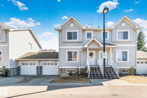 Light grey siding exterior with white trim and a covered front entry - 53 2503 24 Street, Edmonton, AB - Outdoor With Facade