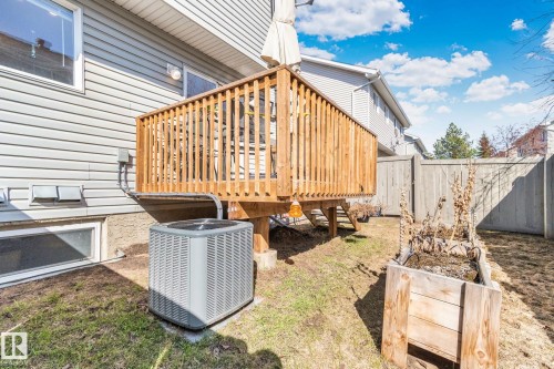 Wood-toned deck with slatted railings and a visible air conditioning unit - 53 2503 24 Street, Edmonton, AB - Outdoor With Deck Patio Veranda With Exterior