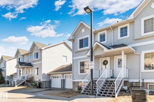 Row of two-story townhomes featuring light-colored siding and gabled rooflines - 53 2503 24 Street, Edmonton, AB - Outdoor With Facade