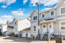 Row of two-story townhomes featuring light-colored siding and gabled rooflines - 53 2503 24 Street, Edmonton, AB  - Outdoor With Facade 