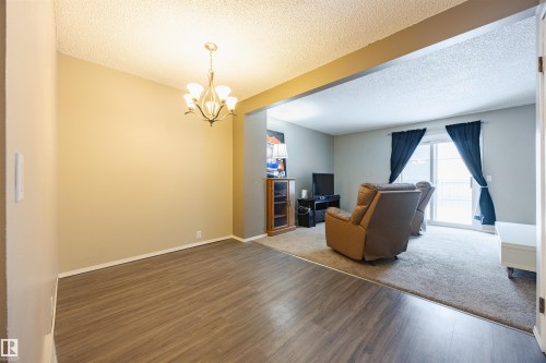 The property features distinct flooring, with wood-look flooring in one area and carpeting in the other - Sherwood Park, AB - Indoor