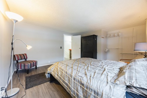 This room features light grey walls and wood-look flooring - Sherwood Park, AB - Indoor Photo Showing Bedroom