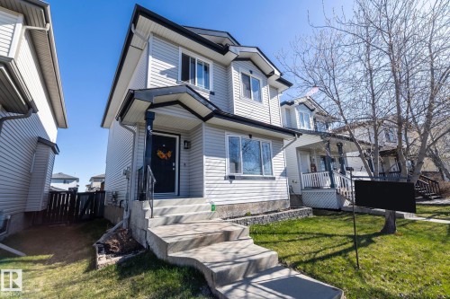 Two-story residence featuring light-colored siding and a contrasting dark roofline - 65 Birchmont Drive, Leduc, AB - Outdoor