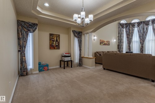 Spacious interior featuring a coffered ceiling with recessed lighting and a chandelier - 195 Kulawy Drive, Edmonton, AB - Indoor Photo Showing Other Room