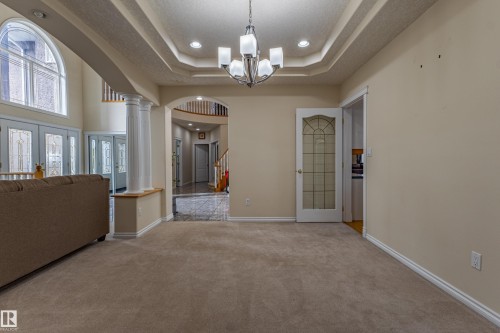 Carpeted room featuring a decorative tray ceiling with a chandelier and recessed lighting - 195 Kulawy Drive, Edmonton, AB - Indoor Photo Showing Other Room