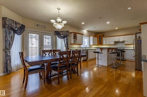 Spacious kitchen and dining area with hardwood flooring throughout - 195 Kulawy Drive, Edmonton, AB - Indoor Photo Showing Dining Room