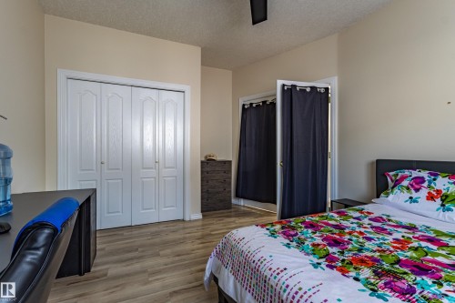 Interior space featuring wood-finish flooring, light-toned walls, and a textured ceiling - 195 Kulawy Drive, Edmonton, AB - Indoor Photo Showing Bedroom