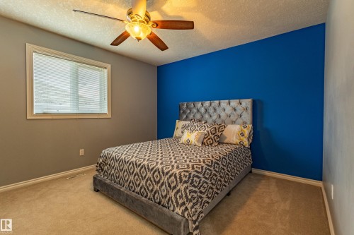 Bedroom featuring a window with blinds, a ceiling fan with integrated lighting, and carpet flooring - 195 Kulawy Drive, Edmonton, AB - Indoor Photo Showing Bedroom