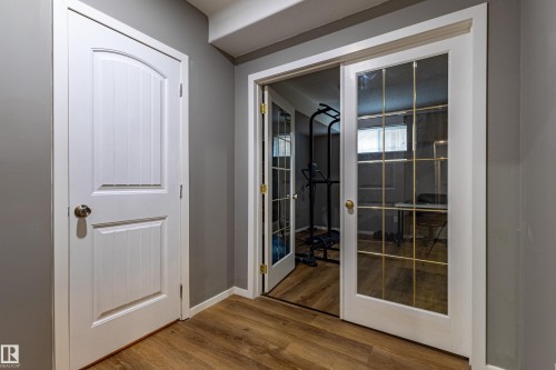 Interior hallway featuring wood-finish flooring, light gray walls, and white trim - 195 Kulawy Drive, Edmonton, AB - Indoor Photo Showing Other Room