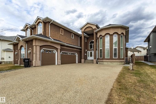 Stucco exterior featuring a prominent two-story bay window with arched frames - 195 Kulawy Drive, Edmonton, AB - Outdoor With Facade