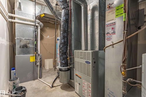 Utility area featuring a Carrier HVAC unit, water heater, and extensive ductwork - 195 Kulawy Drive, Edmonton, AB - Indoor Photo Showing Basement