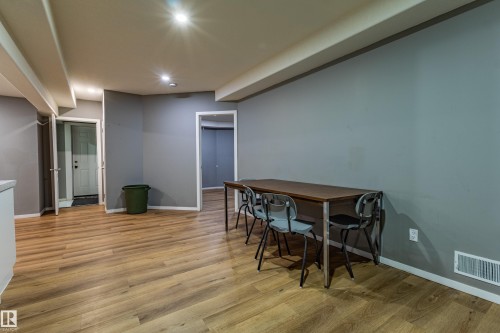 Open-concept room featuring wood-finish flooring, recessed lighting, and a neutral wall color - 195 Kulawy Drive, Edmonton, AB - Indoor