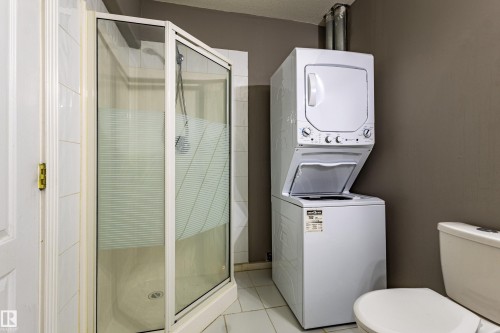 Glass-enclosed shower with a translucent privacy film and a white tiled surround - 195 Kulawy Drive, Edmonton, AB - Indoor