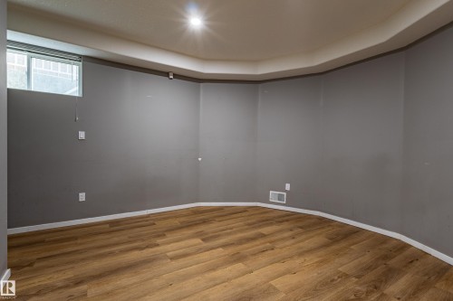 Room with wood-finish flooring, neutral gray walls, and white baseboards - 195 Kulawy Drive, Edmonton, AB - Indoor Photo Showing Other Room