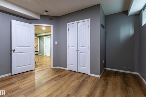 Room featuring wood-finish flooring, neutral gray walls, and white trim - 195 Kulawy Drive, Edmonton, AB - Indoor Photo Showing Other Room