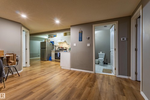 Open-concept living space featuring wood-finish flooring, recessed lighting, and neutral wall tones - 195 Kulawy Drive, Edmonton, AB - Indoor Photo Showing Other Room