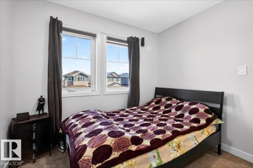 Room featuring two windows, neutral wall tones, and dark trim - 5315 22 Avenue, Edmonton, AB - Indoor Photo Showing Bedroom