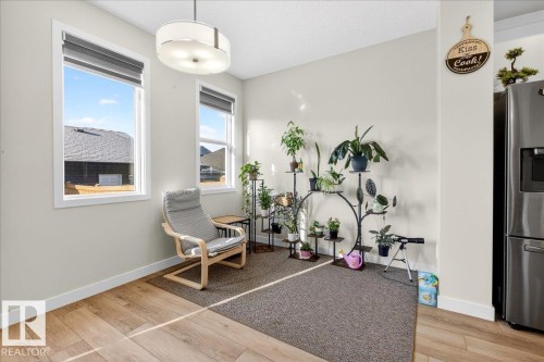 Recessed lighting and a contemporary ceiling fixture illuminate this space, featuring two large windows with roller shades - 5315 22 Avenue, Edmonton, AB - Indoor