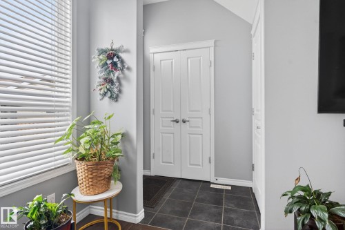 Entryway featuring dark square tile flooring - 6912 22 Avenue, Edmonton, AB - Indoor Photo Showing Other Room