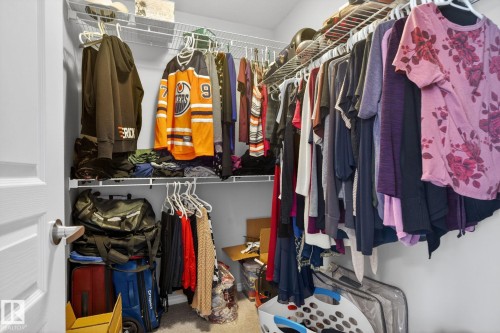 Walk-in closet featuring white wire shelving, multiple hanging rods, and light gray wall paint - 6912 22 Avenue, Edmonton, AB - Indoor With Storage