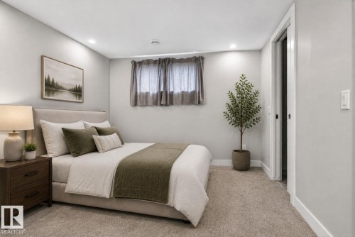 Plush carpet flooring complements light-toned walls and recessed ceiling lighting - 6912 22 Avenue, Edmonton, AB - Indoor Photo Showing Bedroom