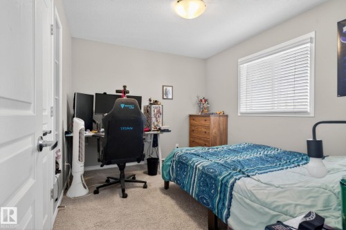 Carpeted room with neutral wall paint and a flush-mount ceiling light fixture - 6912 22 Avenue, Edmonton, AB - Indoor Photo Showing Bedroom