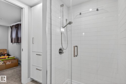 Glass-enclosed shower with subway tile surround, polished chrome fixtures, and a clear glass door with a brushed nickel handle - 6912 22 Avenue, Edmonton, AB - Indoor Photo Showing Bathroom