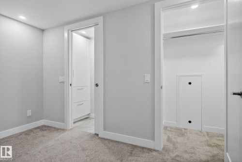 Neutral gray walls with white trim and gray carpeting - 6912 22 Avenue, Edmonton, AB - Indoor Photo Showing Other Room