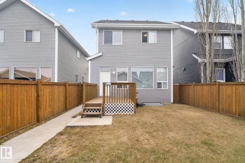 Private backyard featuring a wood deck, concrete pathway, and perimeter wood fencing - 6912 22 Avenue, Edmonton, AB - Outdoor With Deck Patio Veranda With Exterior