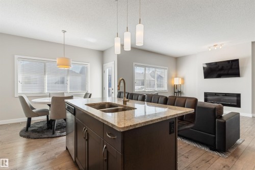 8011 Evans Crescent, Edmonton, AB - Indoor Photo Showing Kitchen With Fireplace With Double Sink