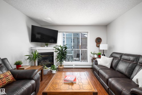 340 17447 98A Avenue, Edmonton, AB - Indoor Photo Showing Living Room With Fireplace