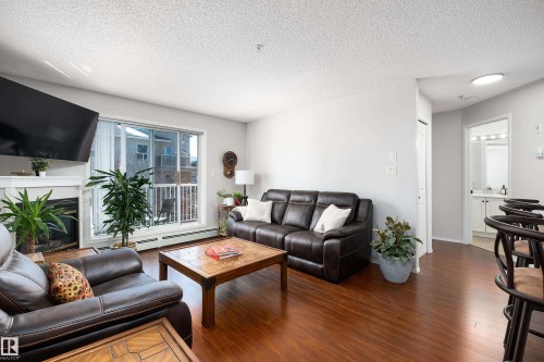 340 17447 98A Avenue, Edmonton, AB - Indoor Photo Showing Living Room With Fireplace