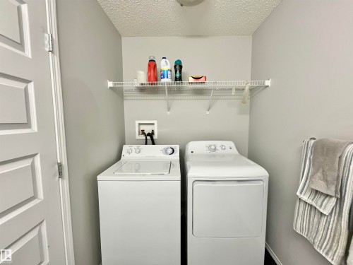 Dedicated laundry area featuring a top-load washing machine and a front-load dryer - 17936 85 Street, Edmonton, AB - Indoor Photo Showing Laundry Room